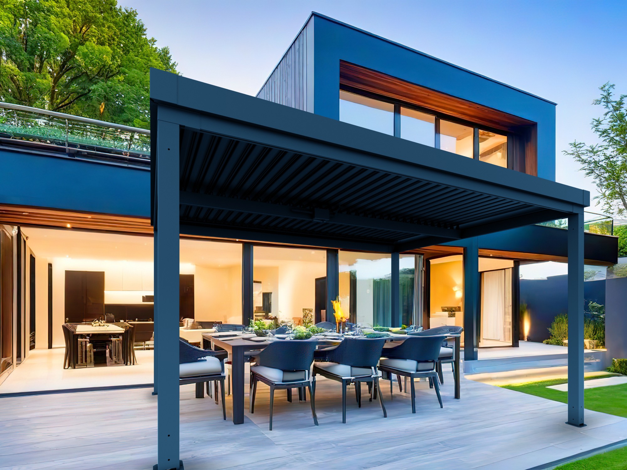 View of luxurious modern house exterior with dining space and garden.